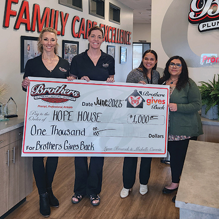 Lynn & Michelle presenting a check to Hope House with Sierra, our team member that nominated them.