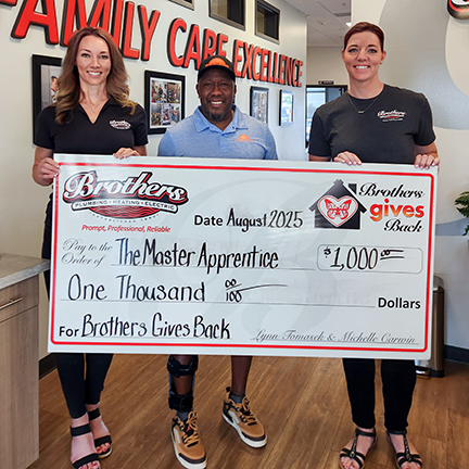 Lynn & Michelle "The Sisters From Brothers" presenting a $1,000 check to The Master Apprentice