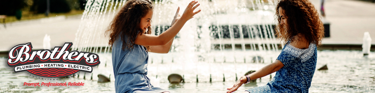 Denver powered water features banner image featuring twin sisters playing in a fountain